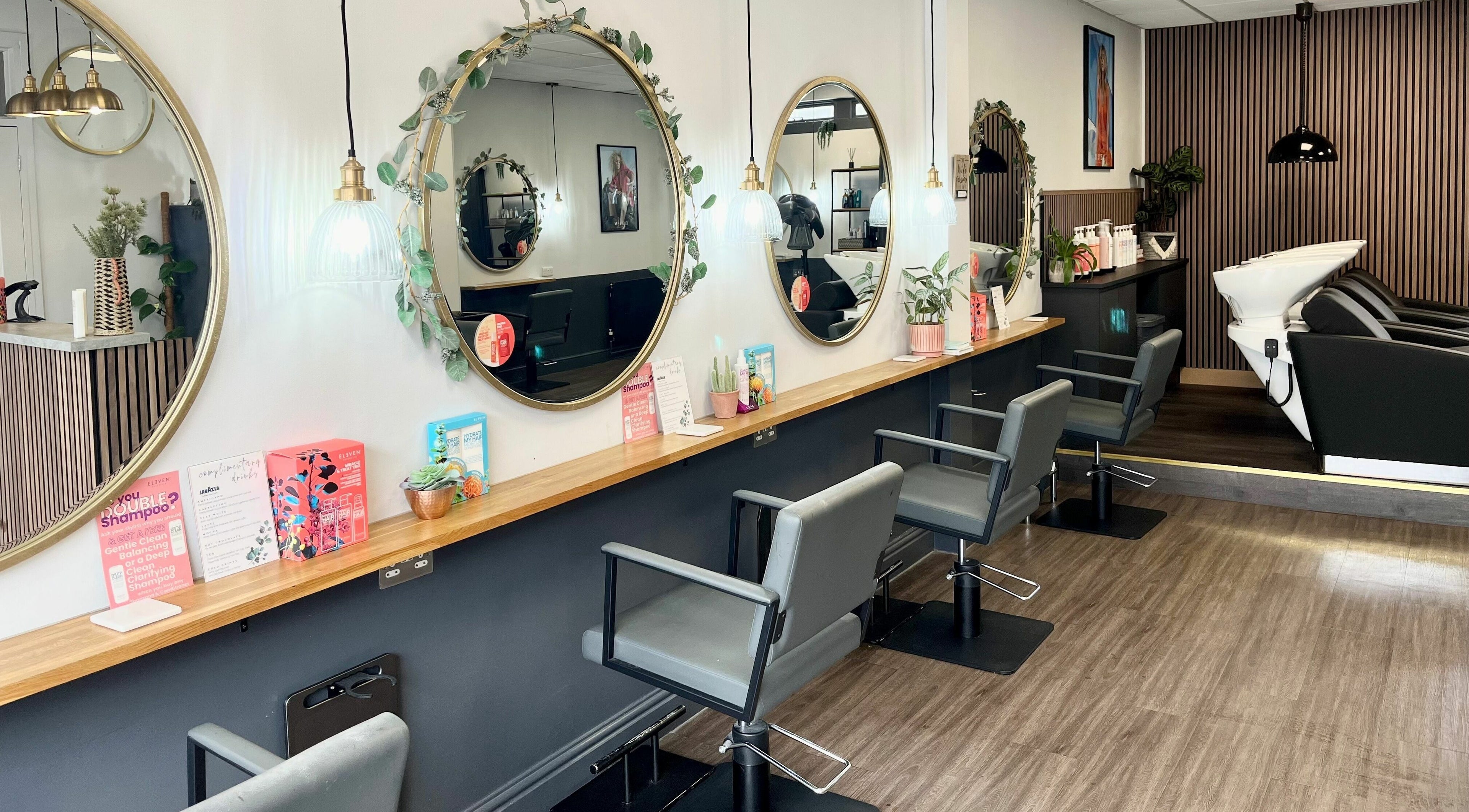 Modern salon interior at West One Hairdressing - West End, West End, England, showcasing chic design and mirrors.