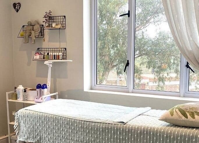 Cozy treatment room at Lily & Lime Beauty Bar, Gqeberha, Eastern Cape, ZA with a massage table and soft lighting.