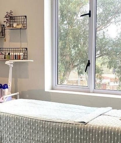 Cozy treatment room at Lily & Lime Beauty Bar, Gqeberha, Eastern Cape, ZA with a massage table and soft lighting.