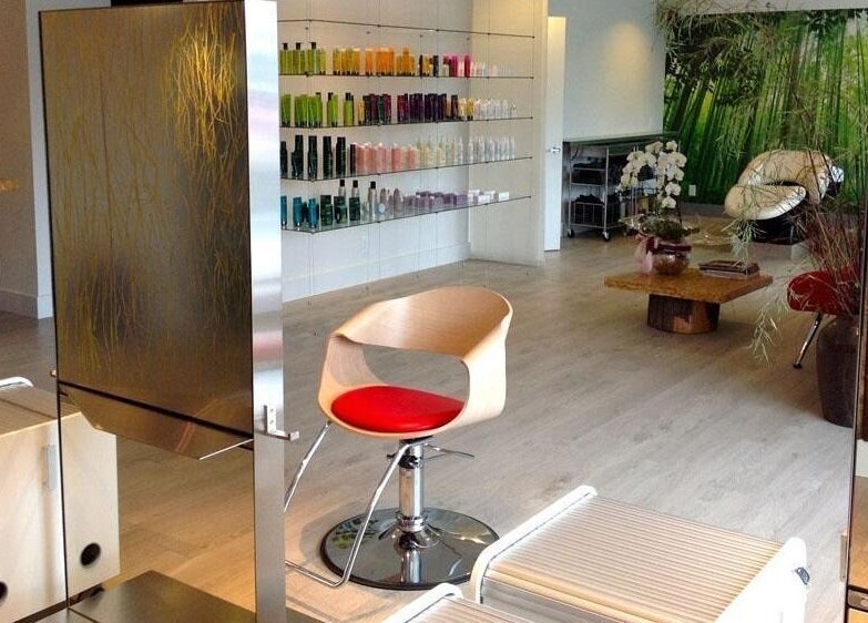 Inside House Of Yoko, North Vancouver, BC: modern styling chair, sleek shelving, lush greenery for a tranquil ambiance.