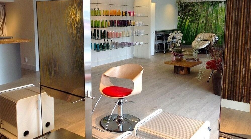 Modern salon setting at House Of Yoko, North Vancouver, British Columbia, CA featuring stylish chair and product display.
