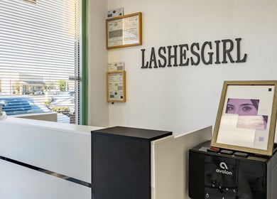 Lashes Girl reception area in West Covina, California, US with chic decor and certificates on display.