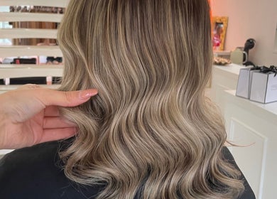 Styled wavy hair showcased at Diane at Aura, Chester, England, GB, in a chic modern salon setting.