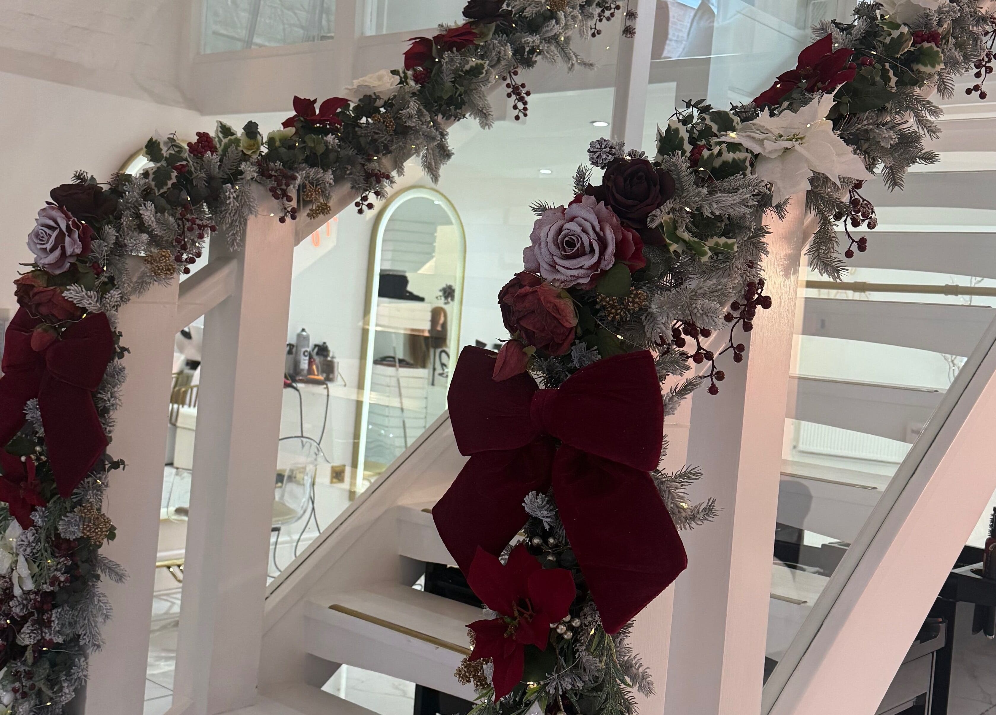 Festive floral garland decorates staircase at Diane at Aura, Chester, England, GB for a welcoming holiday ambiance.