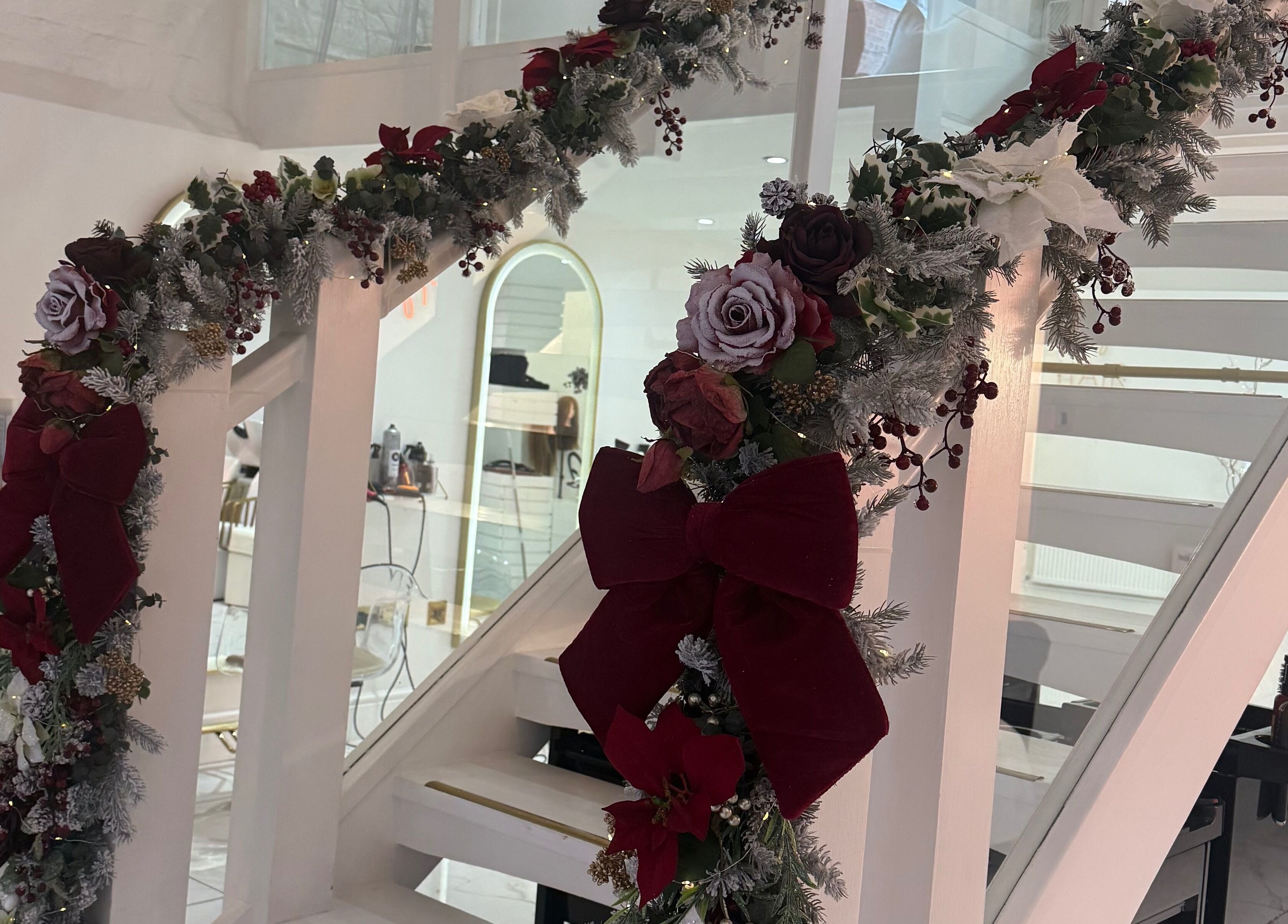 Festive floral garland decorates staircase at Diane at Aura, Chester, England, GB for a welcoming holiday ambiance.
