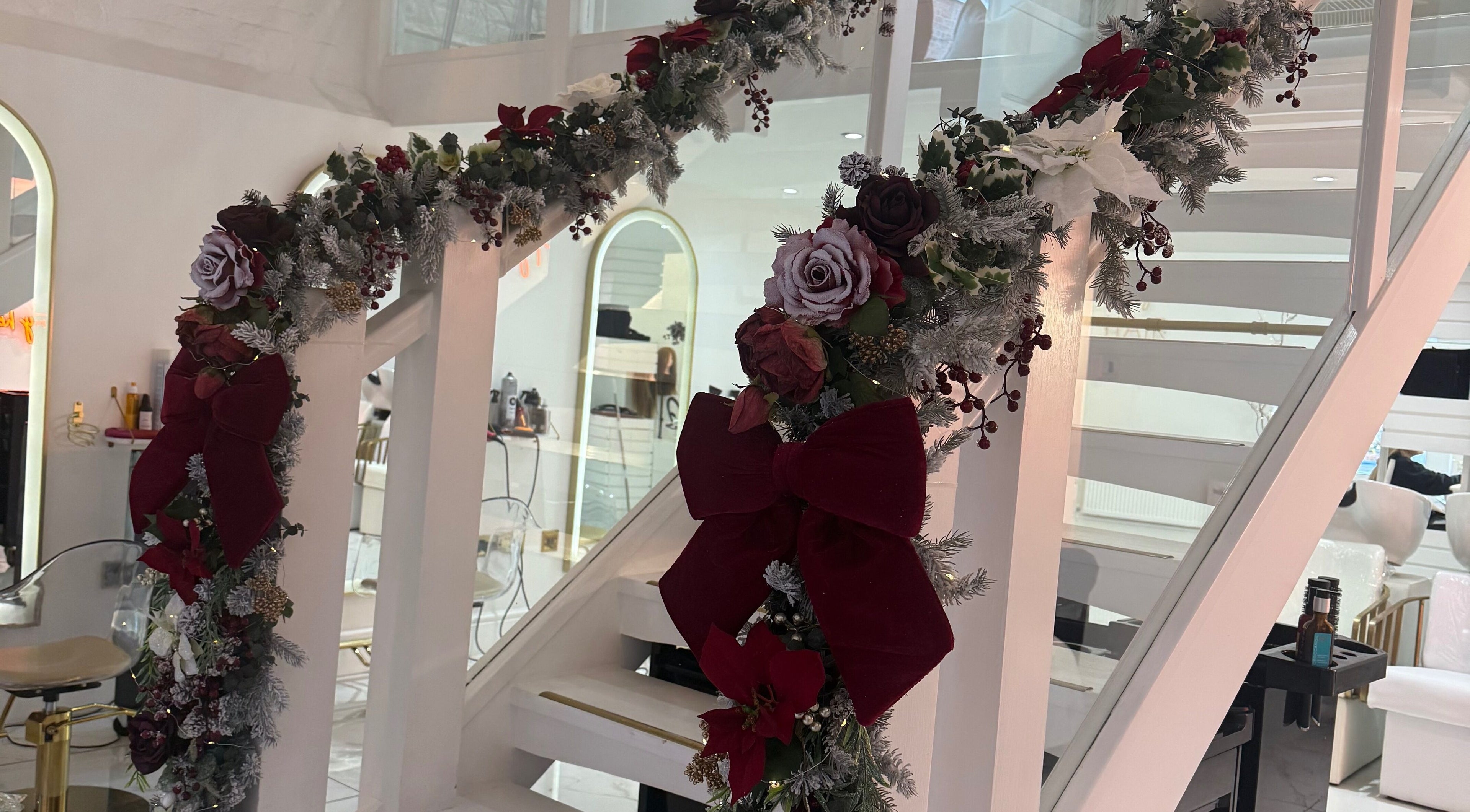 Festive floral garland decorates staircase at Diane at Aura, Chester, England, GB for a welcoming holiday ambiance.