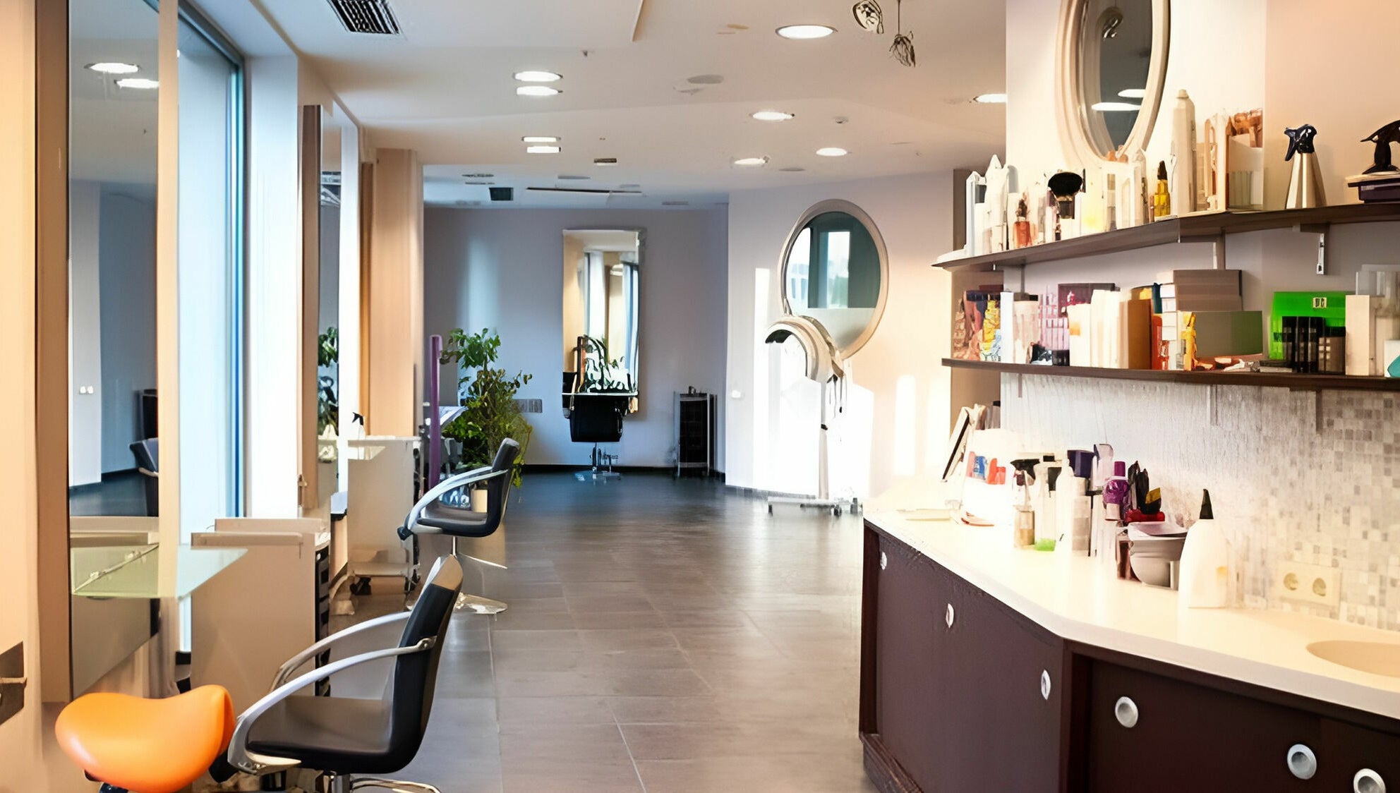 Bright and modern salon interior of LE STUDIO in Rīga, LV, featuring styling chairs and hair care products.