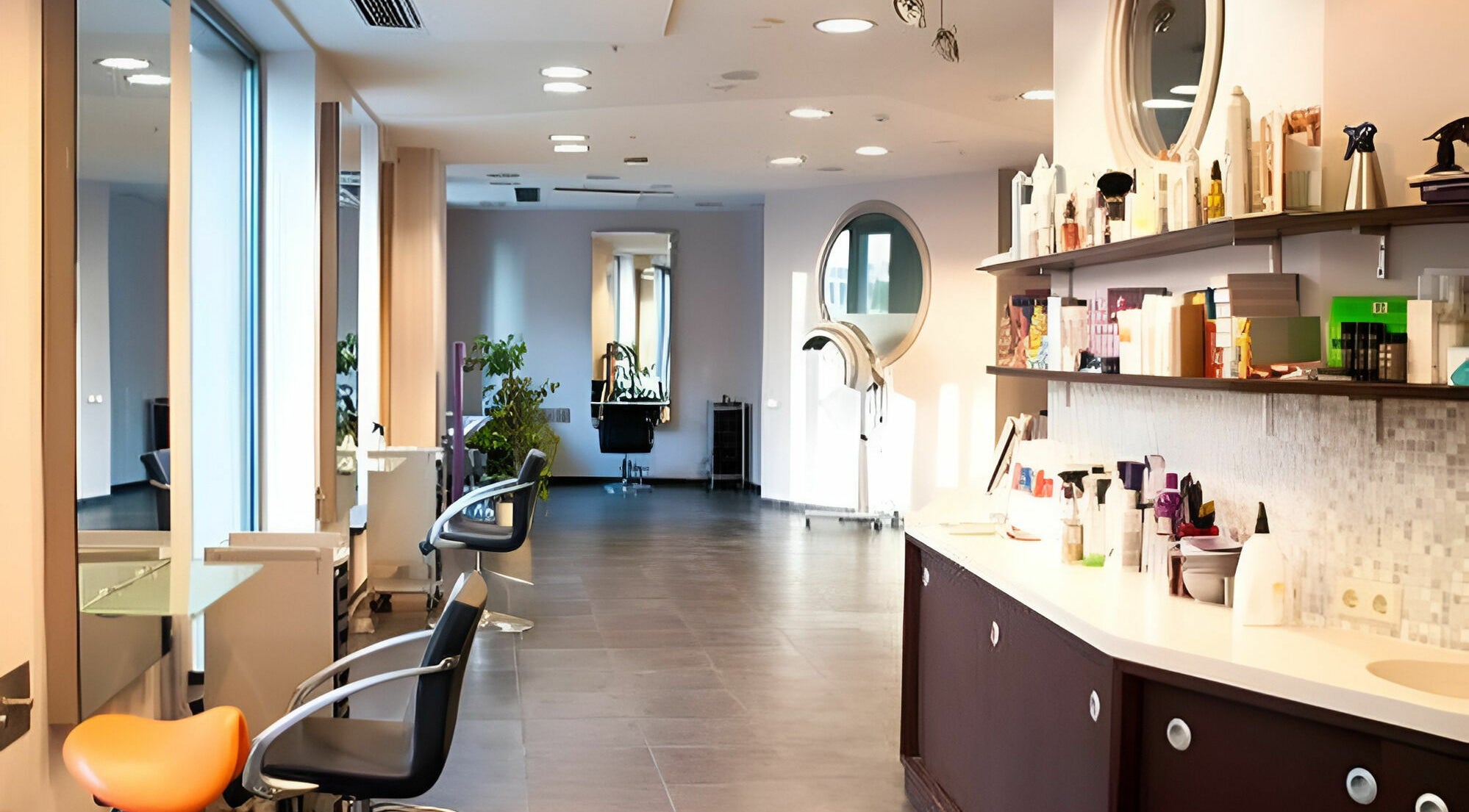 Bright and modern salon interior of LE STUDIO in Rīga, LV, featuring styling chairs and hair care products.