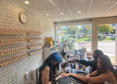 Clients receive manicures at La Crystal Studio in Ottawa, Ontario, CA. Elegant decor with brick walls and natural light.