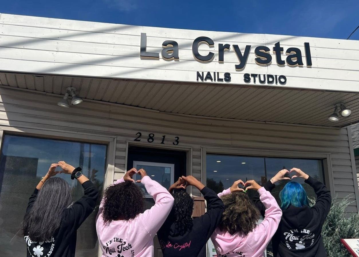 Team outside La Crystal Nail Studio, Ottawa, Ontario, CA showing heart gestures under the studio sign.