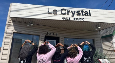 Team outside La Crystal Nail Studio, Ottawa, Ontario, CA showing heart gestures under the studio sign.