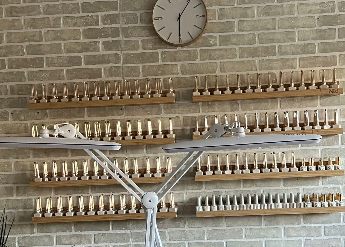 Elegant nail polish shelves at La Crystal Nail Studio in Ottawa, Ontario, CA showcase diverse color options.