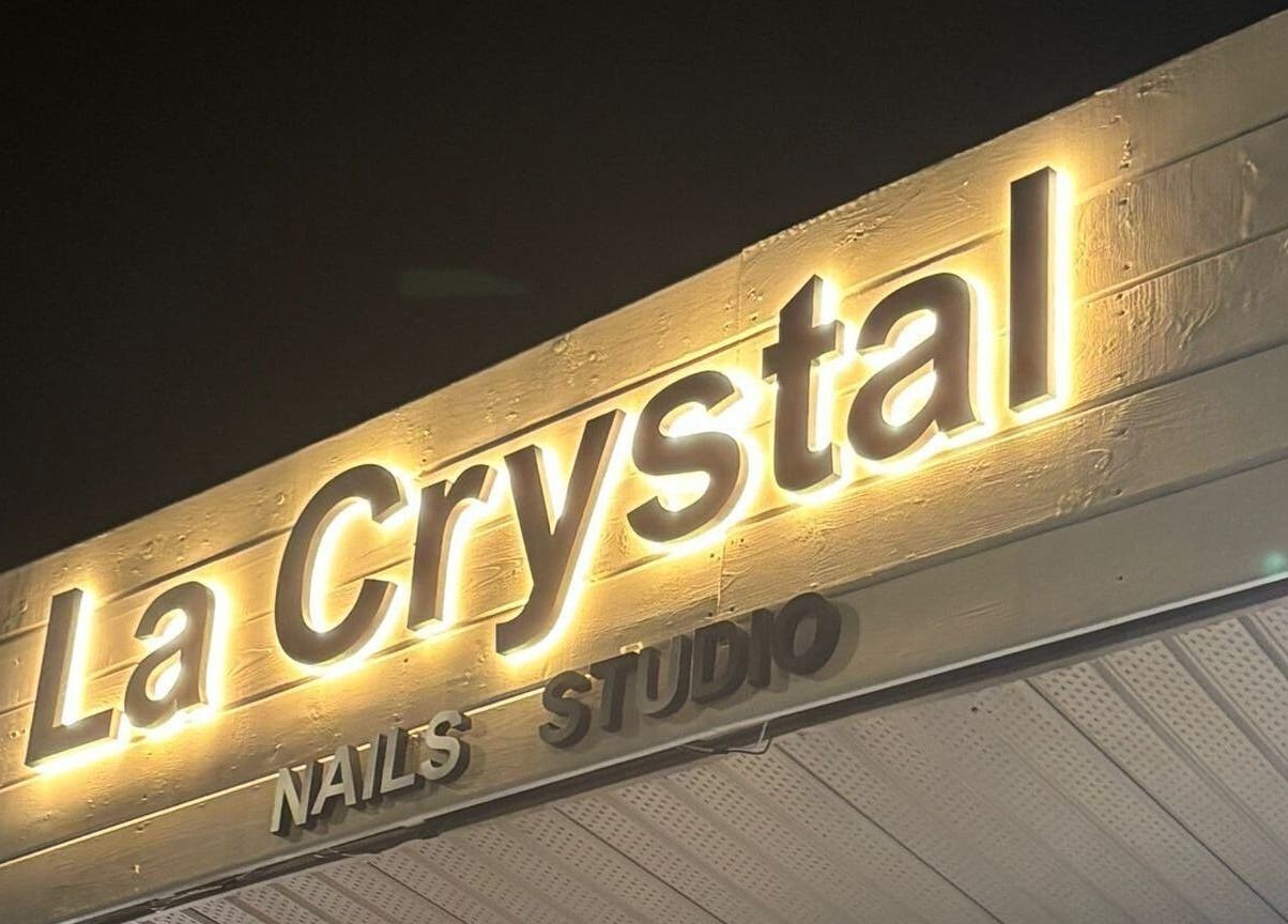 Glowing La Crystal Nail Studio sign in Ottawa, Ontario, CA against a dark backdrop.