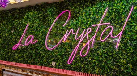 Neon sign 'La Crystal' on vibrant green wall at Studio - 421 A Cumberland Street, Ottawa, Ontario, CA.