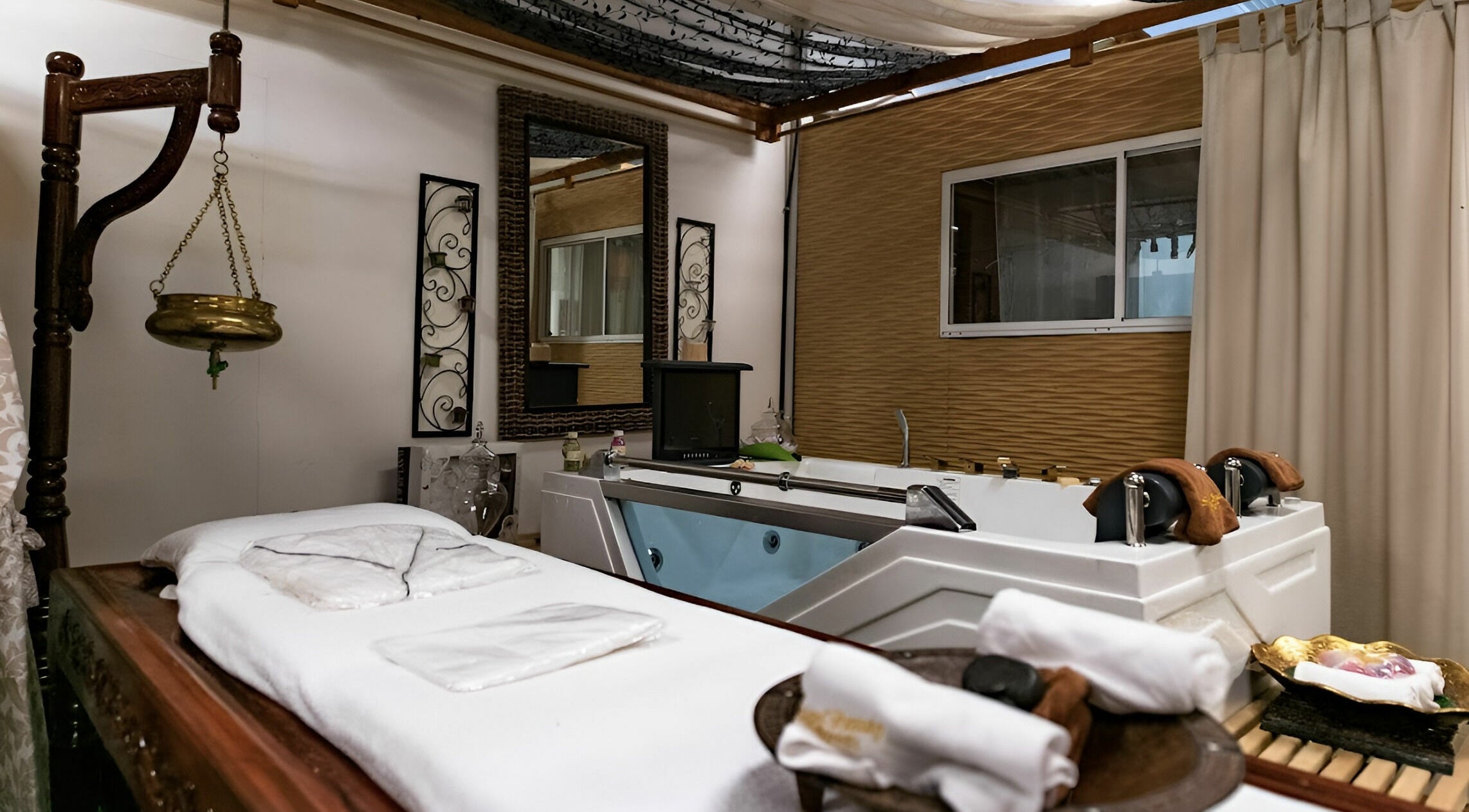 Luxurious spa room at Indian Beauty Secrets | Merrylands, featuring a massage table and Jacuzzi in Merrylands, New South Wales, AU.