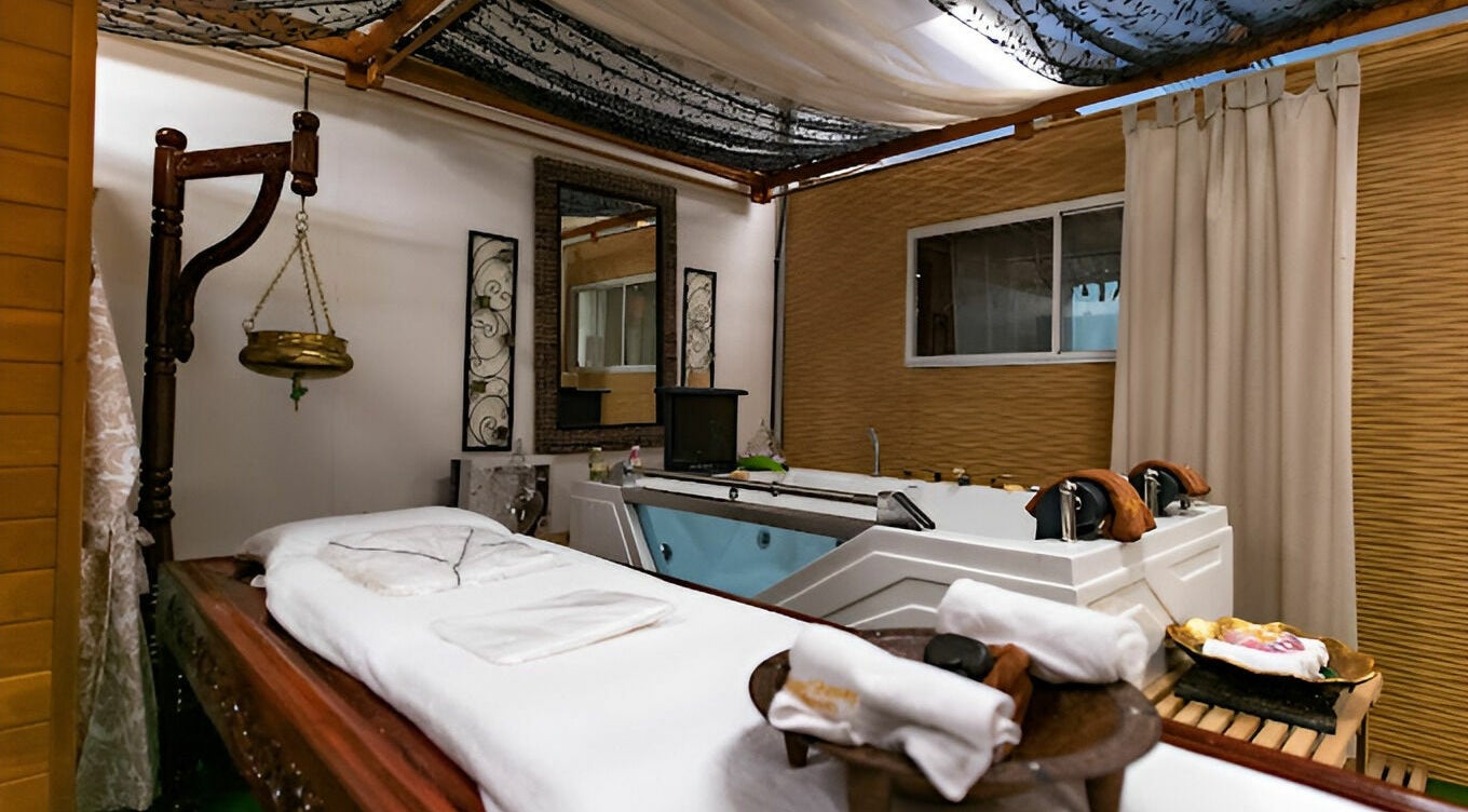 Luxurious spa room at Indian Beauty Secrets | Windsor with massage bed and therapy tub in Windsor, New South Wales, AU.