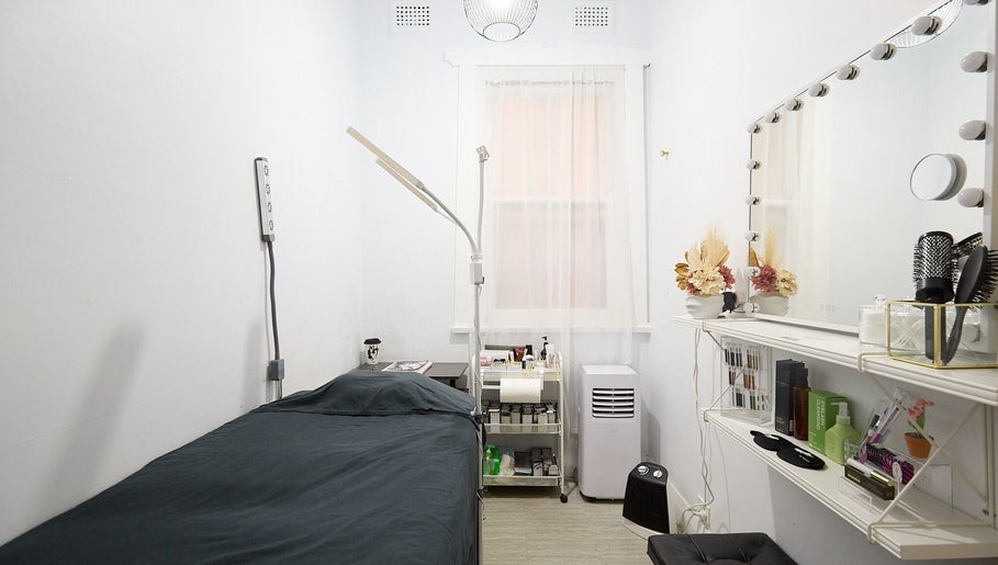 Cozy beauty room at Lashes By Ai in Surry Hills, New South Wales, AU, with a treatment bed and vanity mirror.