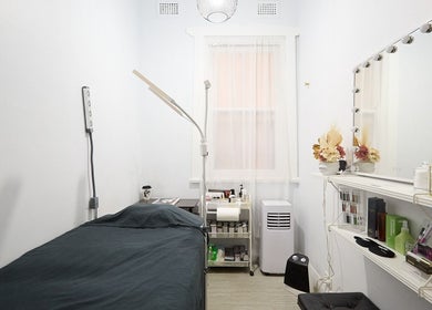 Cozy beauty room at Lashes By Ai in Surry Hills, New South Wales, AU, with a treatment bed and vanity mirror.