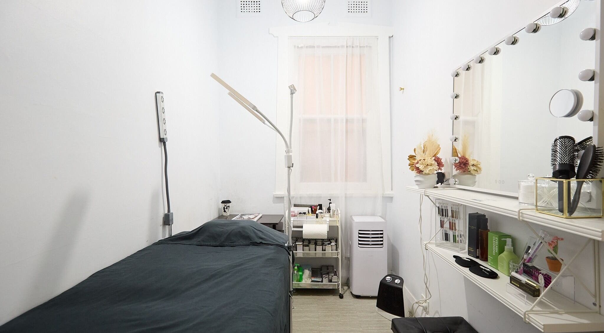 Cozy beauty room at Lashes By Ai in Surry Hills, New South Wales, AU, with a treatment bed and vanity mirror.