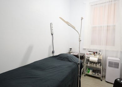 Calm treatment room at Lashes By Ai in Surry Hills, New South Wales, AU, featuring a bed and essential tools.