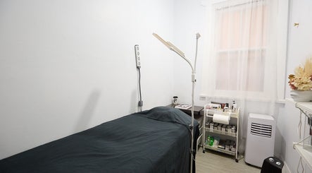 Calm treatment room at Lashes By Ai in Surry Hills, New South Wales, AU, featuring a bed and essential tools.