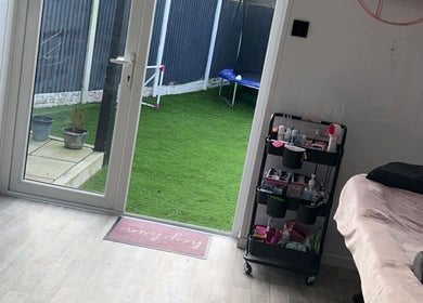 Cozy treatment room at Lashed By Kate, Harworth, England, with beauty tools and garden view.