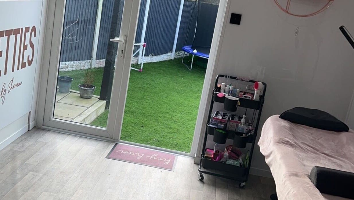 Cozy beauty treatment space at Lashed By Kate in Harworth, England, GB with a view of a lush garden.