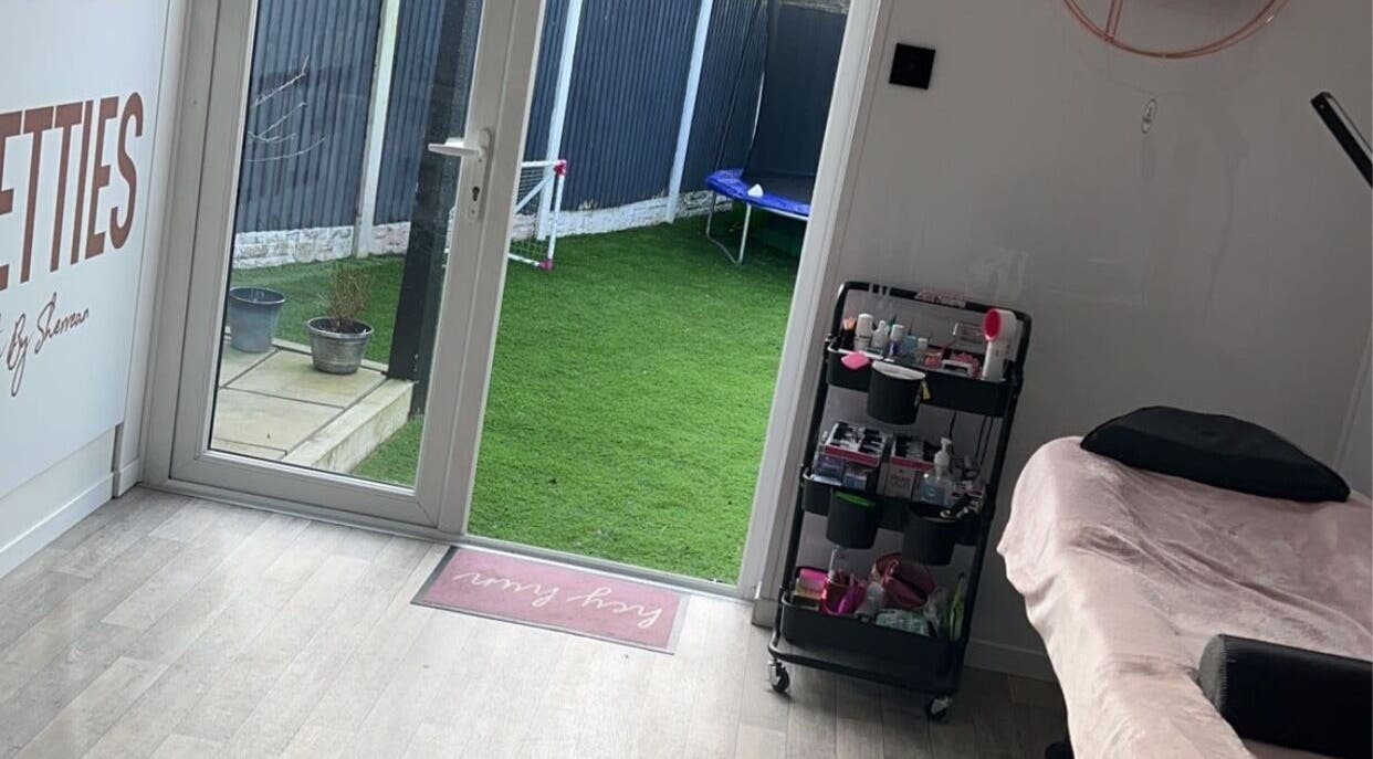 Cozy beauty treatment space at Lashed By Kate in Harworth, England, GB with a view of a lush garden.