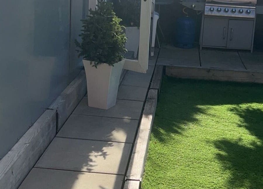 Outdoor patio at Lashed By Kate in Harworth, England, GB with lush greenery and modern decor.