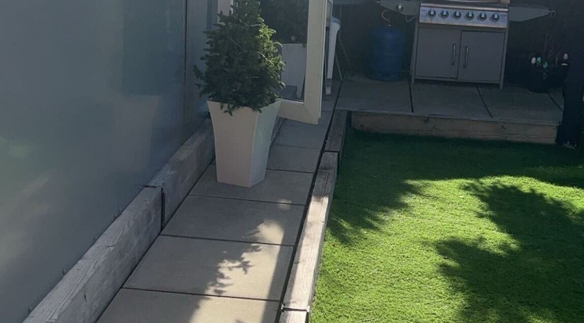 Outdoor patio at Lashed By Kate in Harworth, England, GB with lush greenery and modern decor.