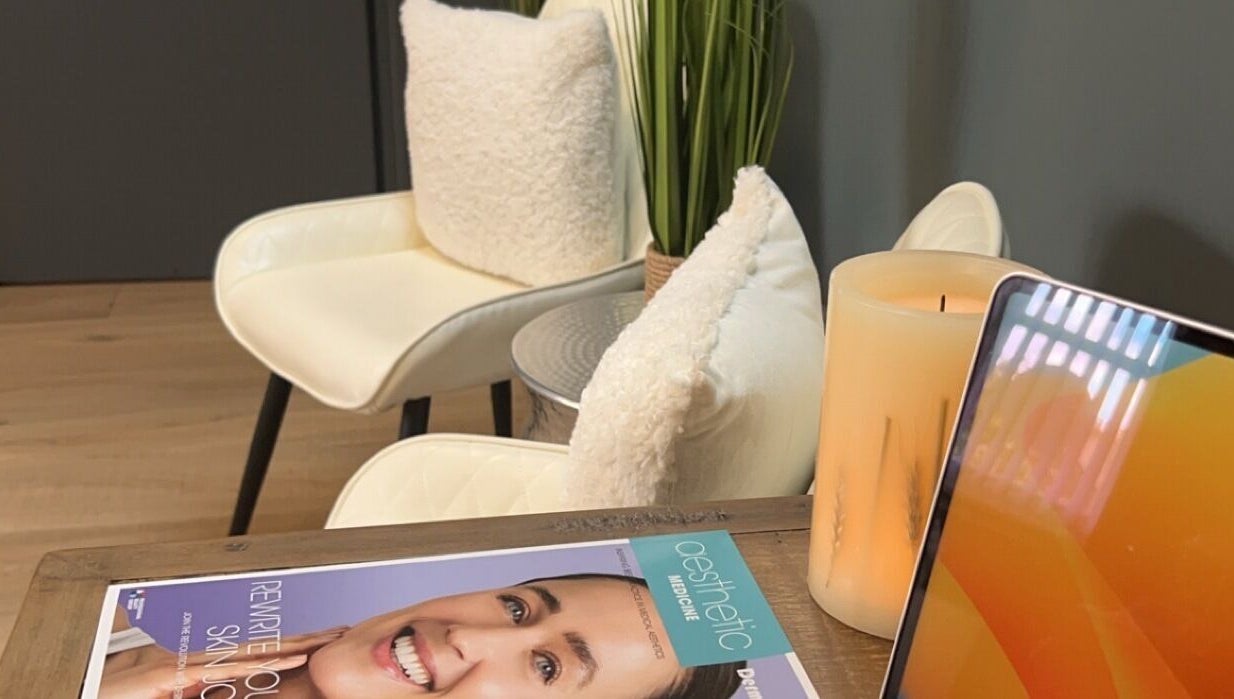 Cozy waiting area at ABM Aesthetics and Beauty in Dunfermline, Scotland, GB with plush chairs and a magazine.