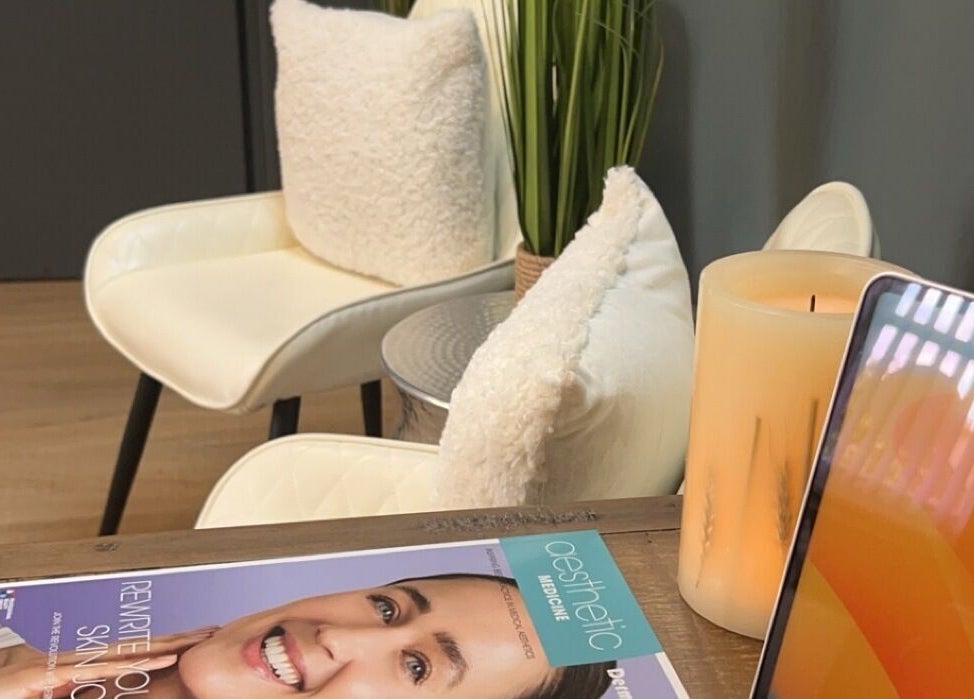 Cozy waiting area at ABM Aesthetics and Beauty in Dunfermline, Scotland, GB with plush chairs and a magazine.