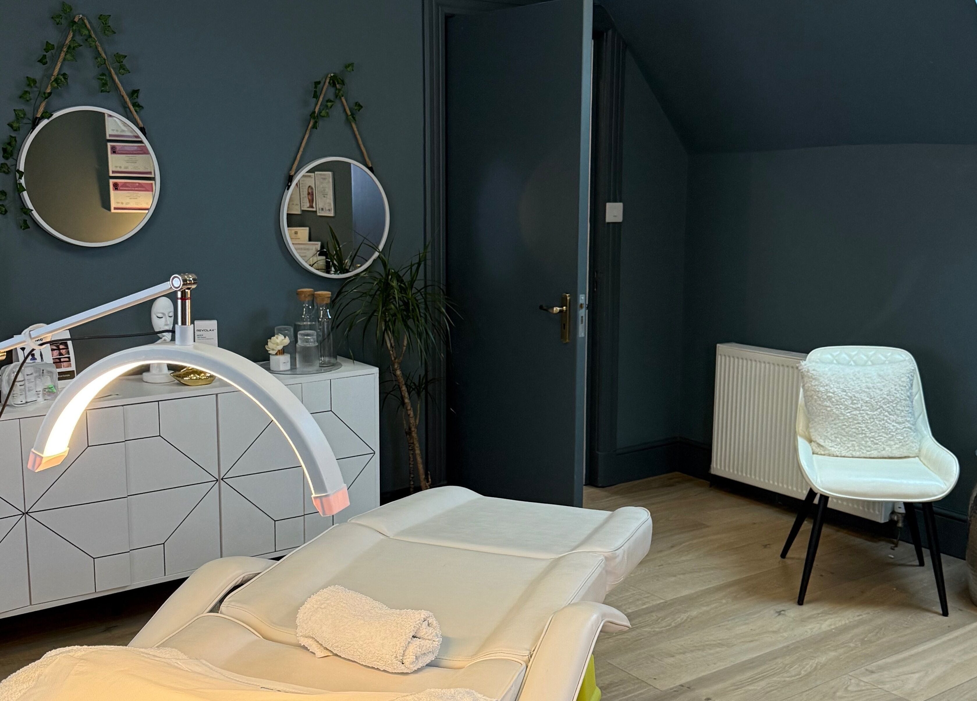 Stylish treatment room at ABM Aesthetics and Beauty, Dunfermline, Scotland, GB with modern decor and treatment bed.