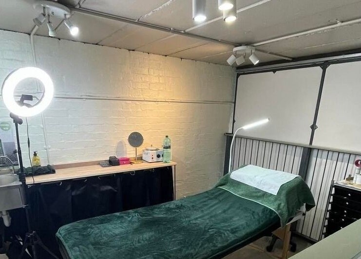 Serene treatment room at Diamond Beauty Zone Ltd, Dundee, Scotland, GB with a cozy massage bed and vanity setup.