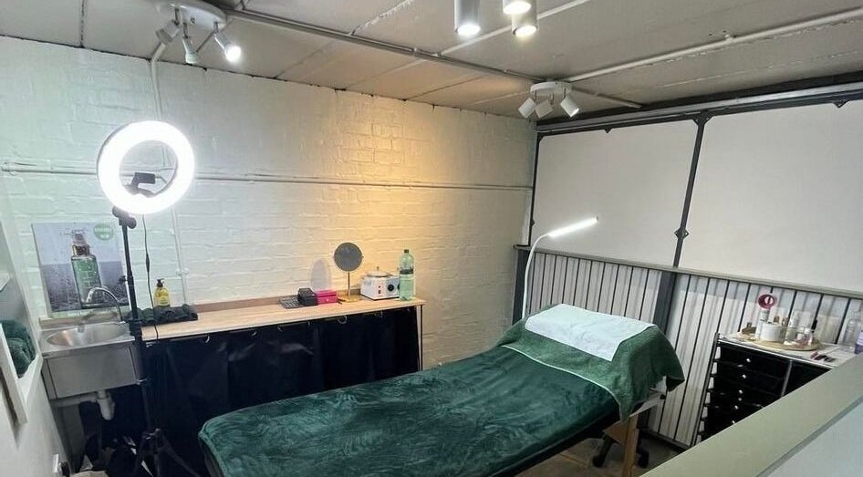 Serene treatment room at Diamond Beauty Zone Ltd, Dundee, Scotland, GB with a cozy massage bed and vanity setup.