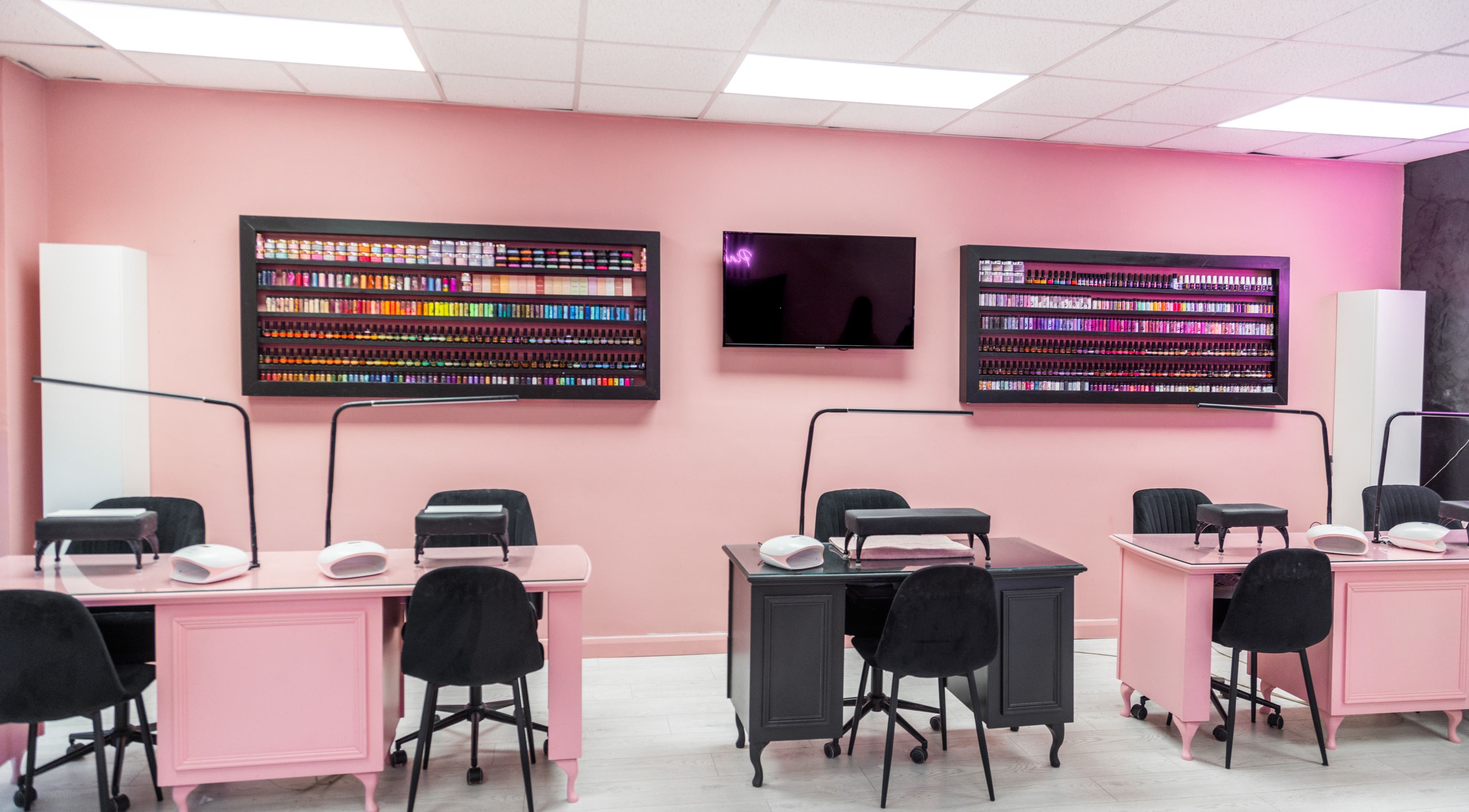 The Pink Room in Warrington, England GB offers chic nail stations with a vibrant polish display.
