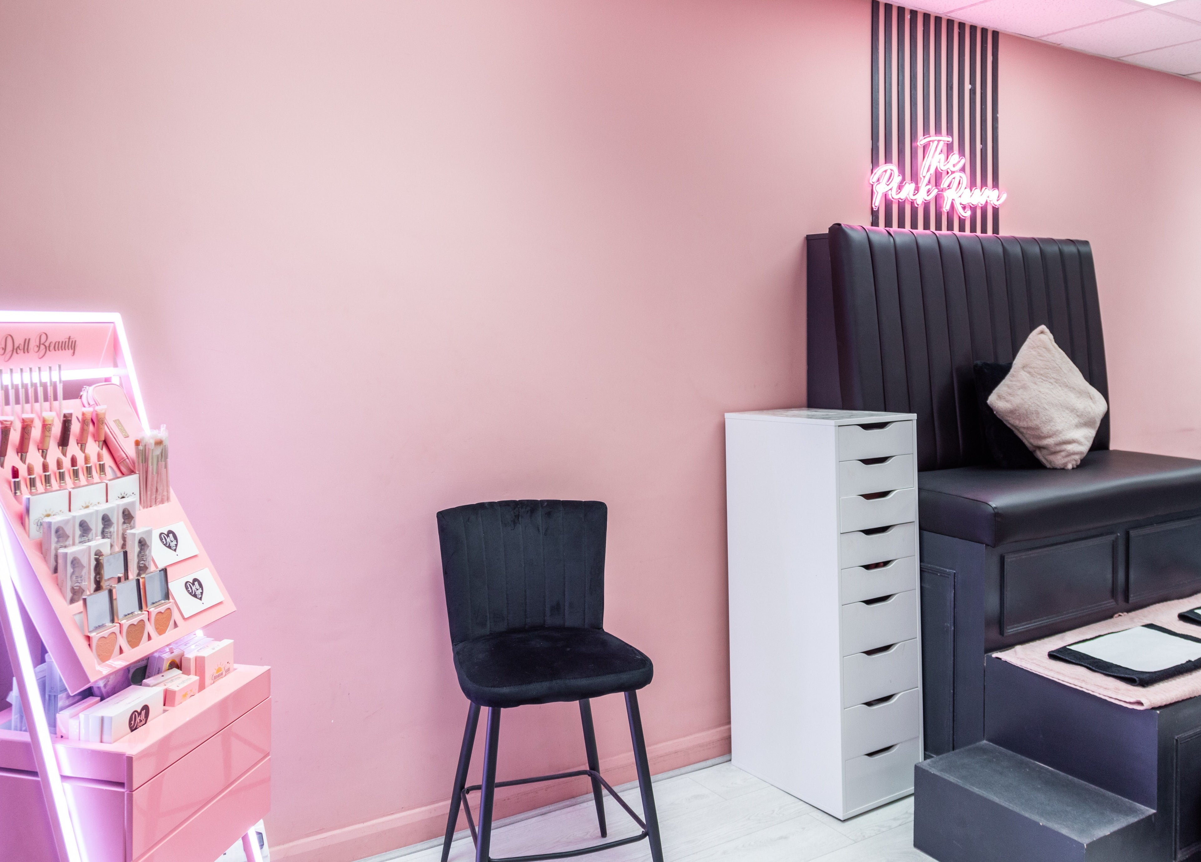 The Pink Room in Warrington, England, GB showcases a chic beauty setup with pink and black decor.