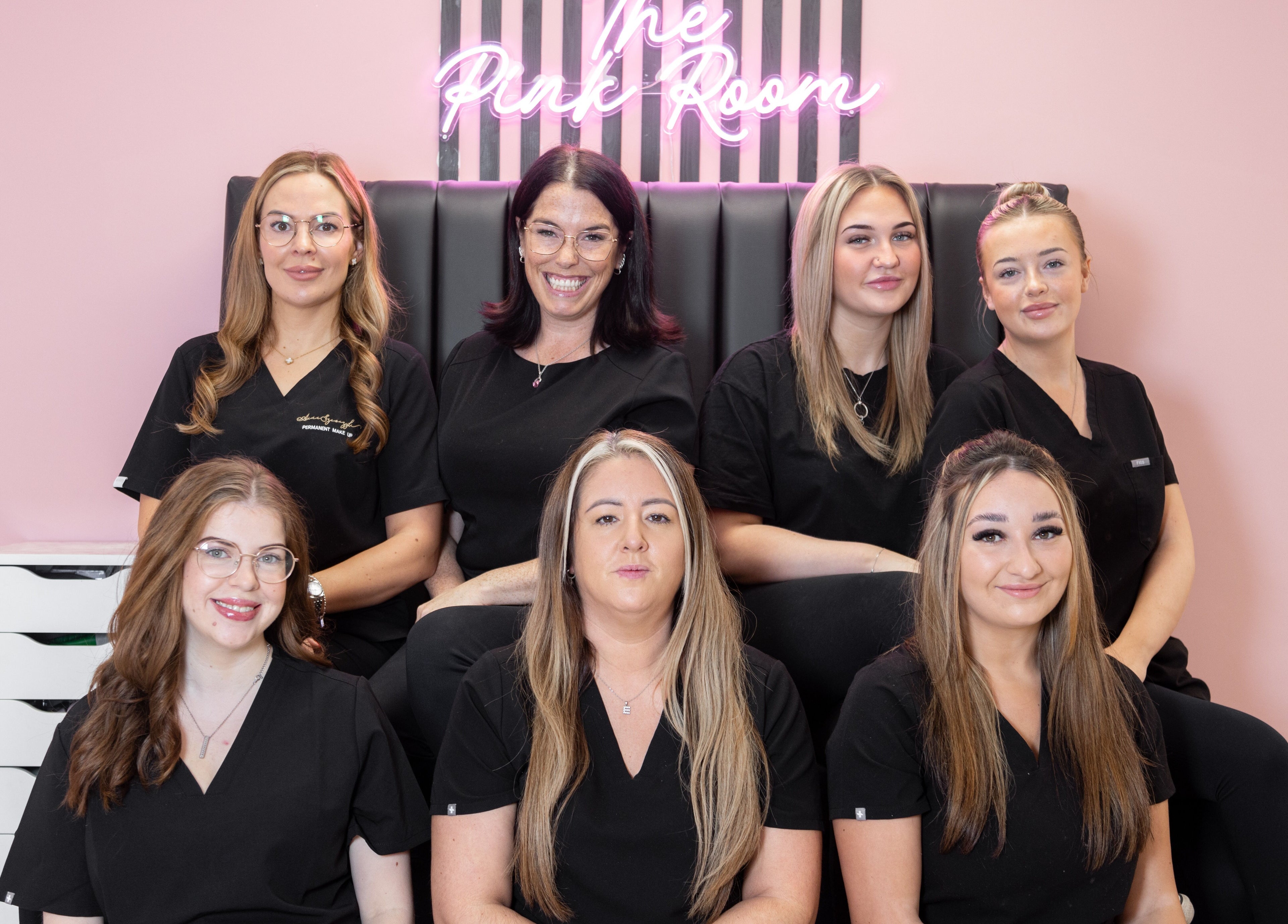 The Pink Room team posing with smiles in Warrington, England, GB, highlighting a welcoming beauty and wellness atmosphere.