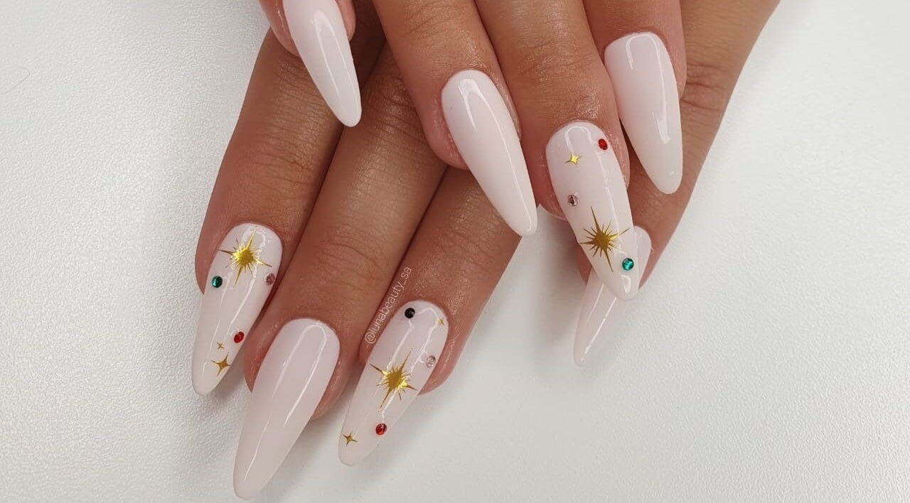 Elegant celestial-themed nails at Luna Beauty, Johannesburg, Gauteng, ZA, featuring gold star accents.