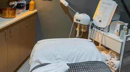 Treatment room at Wax Therapy Hyperdome in Loganholme, Queensland, AU featuring a massage table and skincare equipment.