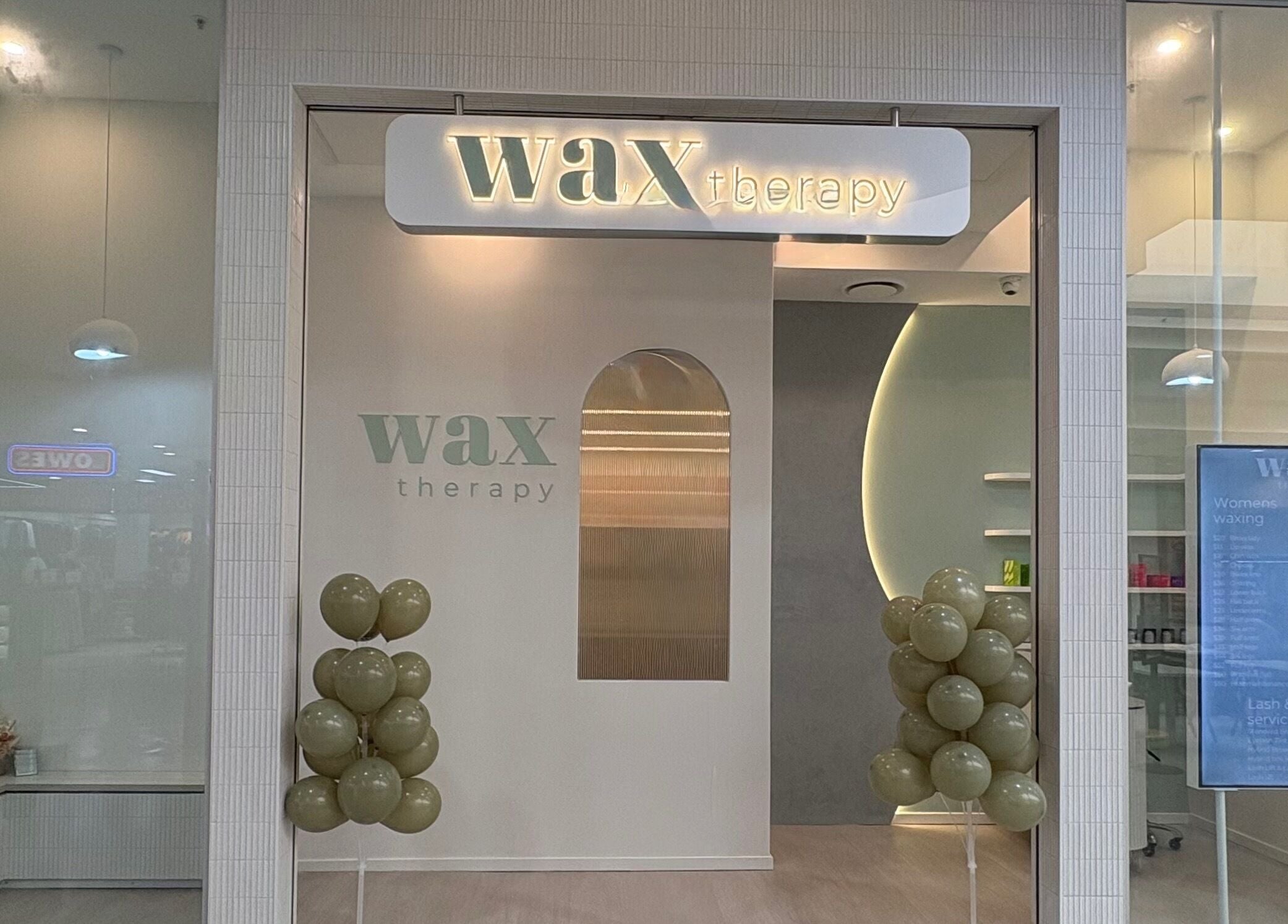 Front view of Wax Therapy Hyperdome in Loganholme, Queensland, AU with elegant balloon decor.