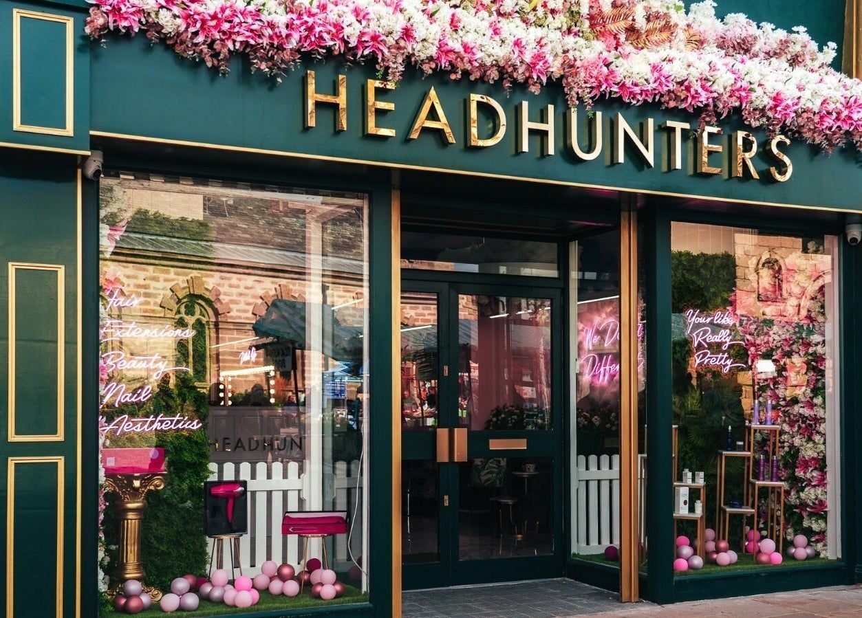 Head Hunters Salon Pontefract entrance adorned with vibrant pink flowers in Pontefract, England, GB.