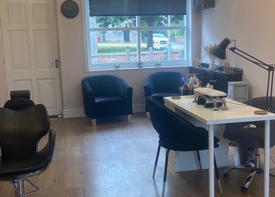 Modern interior view of Lauren Giorgia’s House Of Beauty, Measham, England, with elegant chairs and nail station.