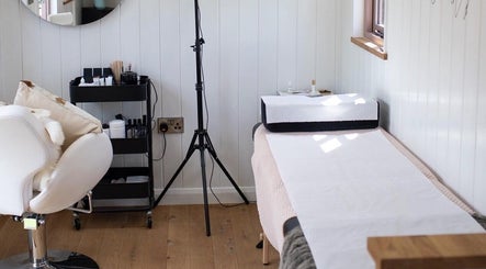 Cozy treatment area at Htj_Beauty, Eccelshall, England, GB, featuring a relaxing massage bed and elegant decor.