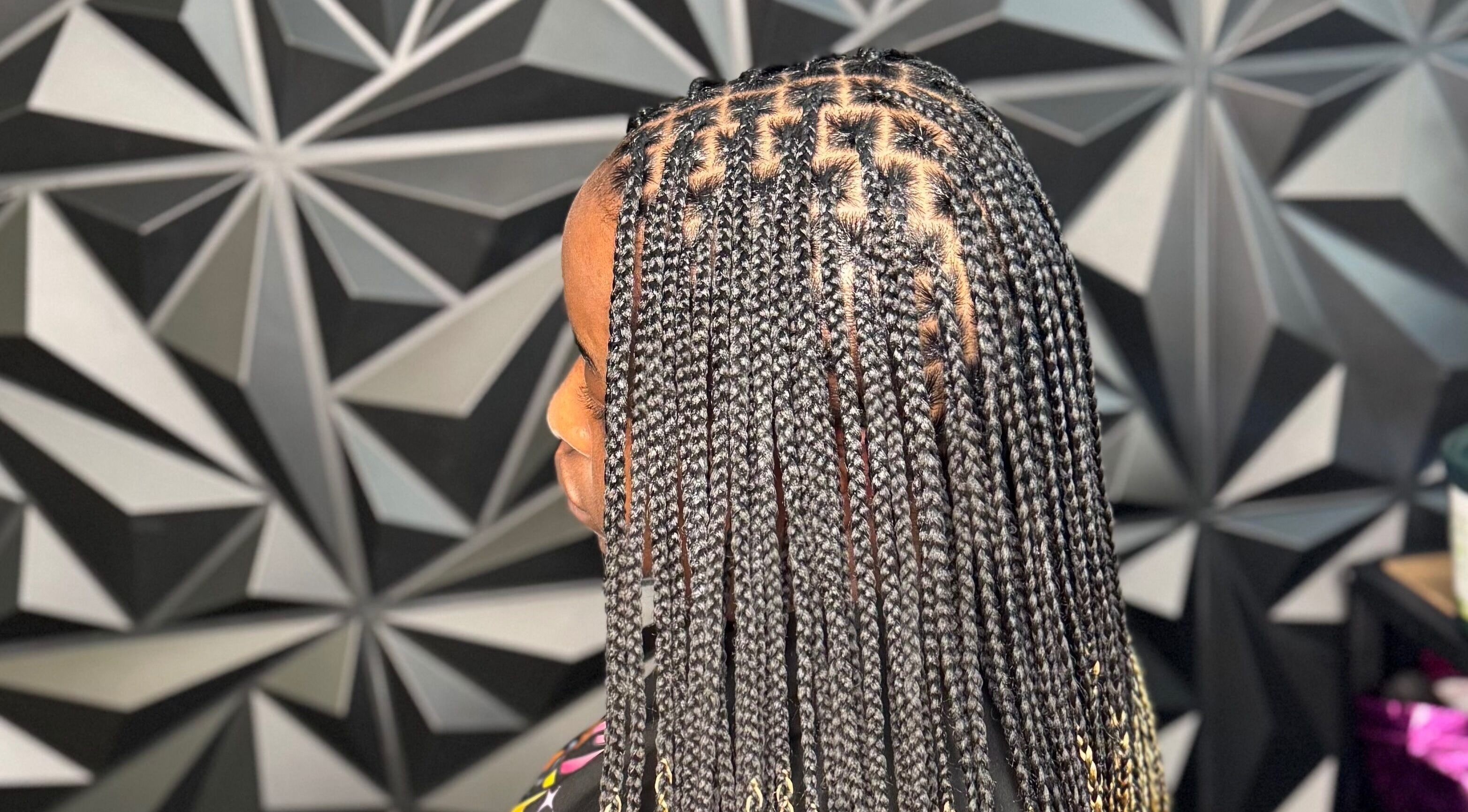 Detailed braided hairstyle at Glam Touch Nail and Hair Salon, Greenwood, South Carolina, US.
