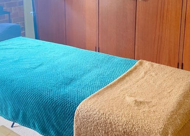 Relaxing therapy room at Jm Beauty Services, Singleton Heights, New South Wales, AU with a cozy treatment bed.