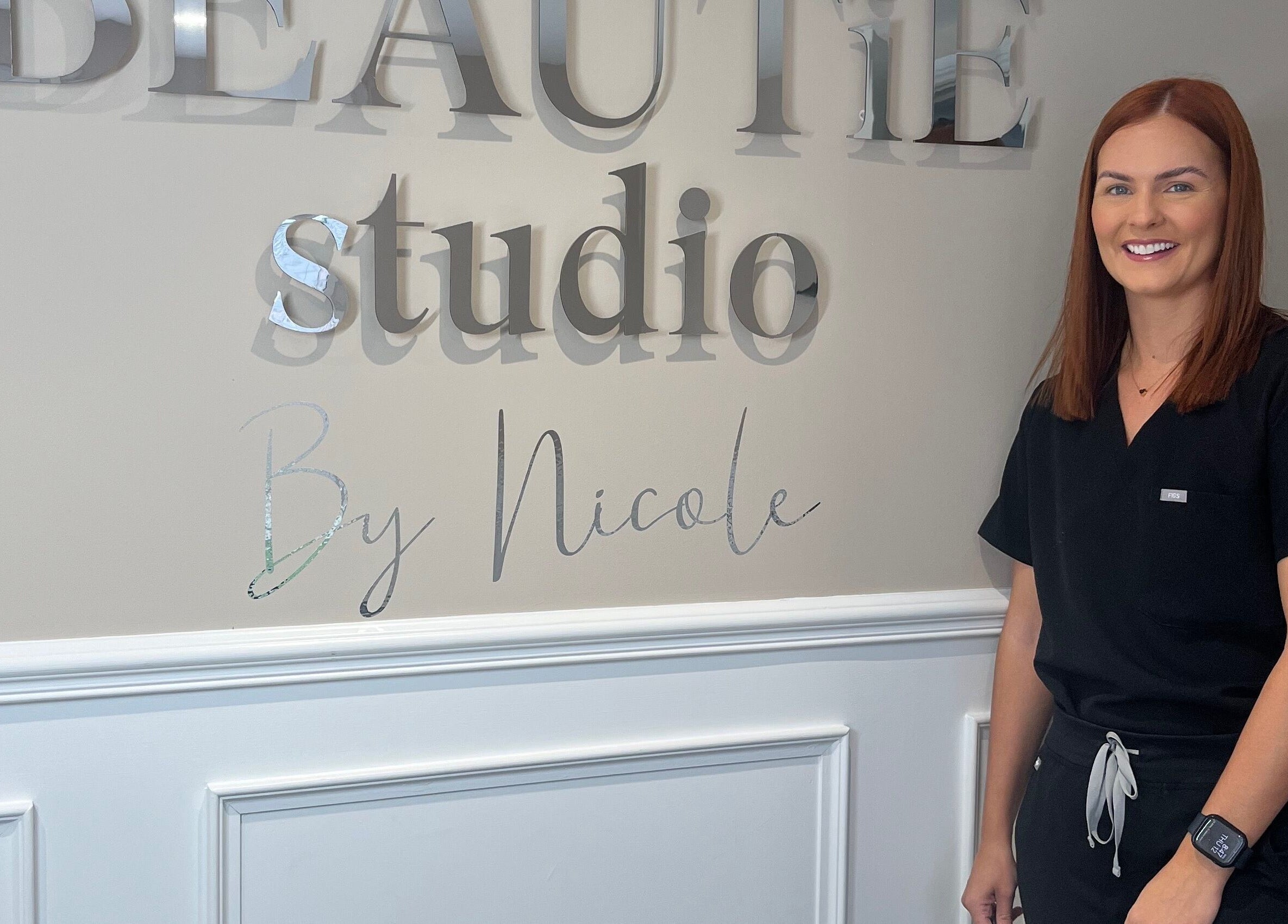 Staff member smiles at The Beautie Studio in Londonderry, Northern Ireland, GB.