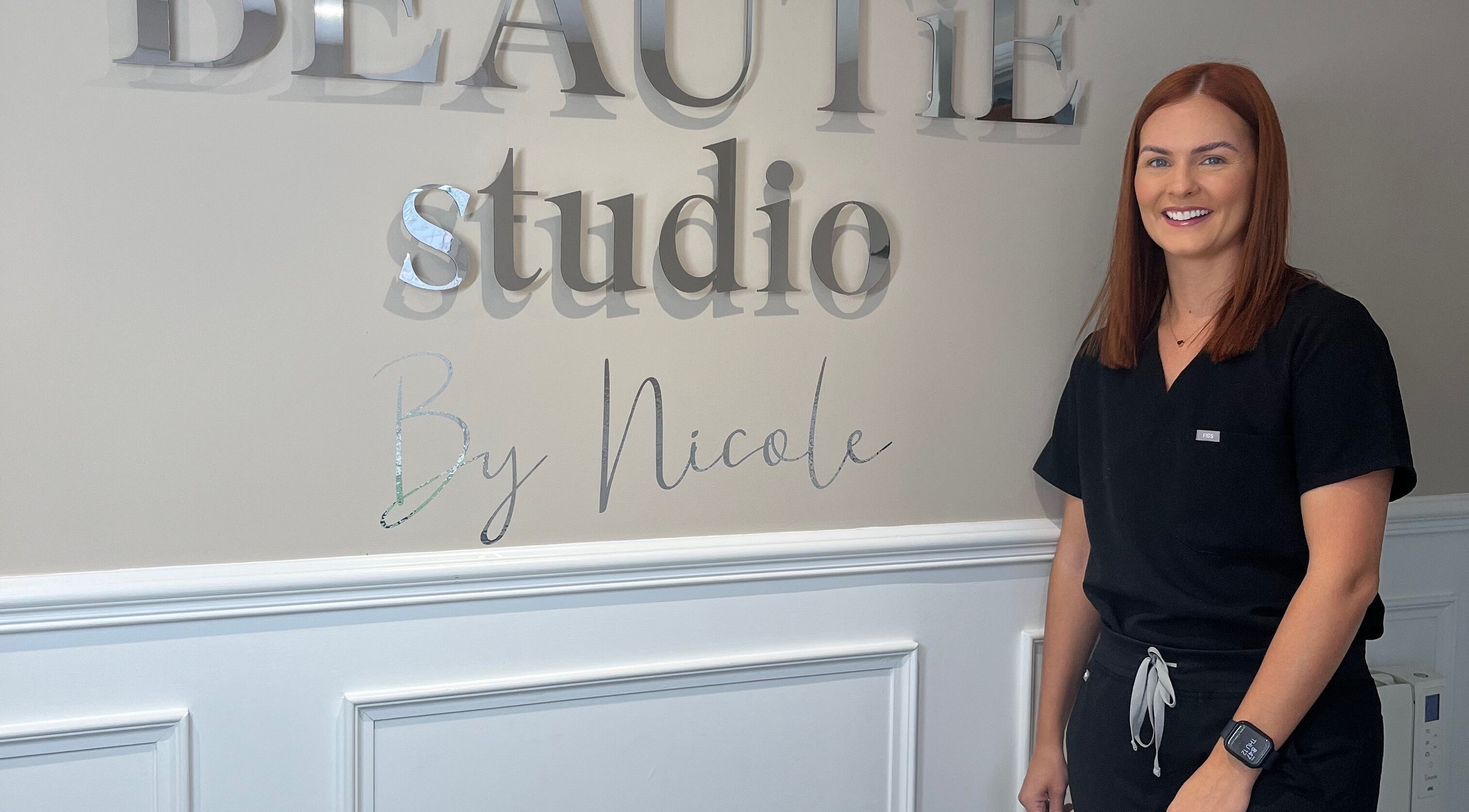Staff member smiles at The Beautie Studio in Londonderry, Northern Ireland, GB.