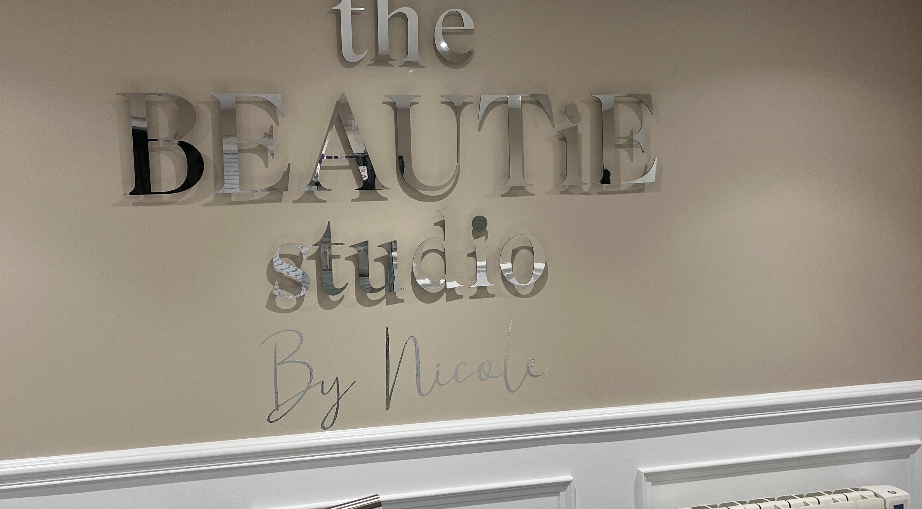 The Beautie Studio's elegant wall sign in Londonderry, Northern Ireland, GB.
