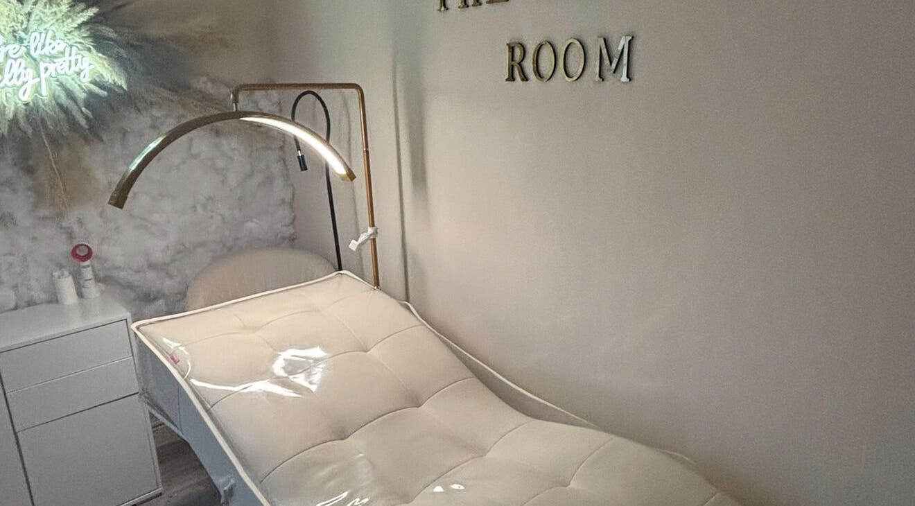 Relaxing treatment room at The Beauty Room, Basingstoke, England, GB with cozy white bed and soft lighting.